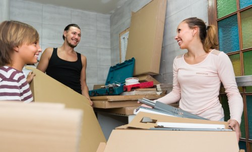 Professional packing team organising household boxes during a local removal