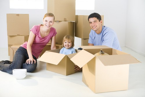 Removal team sorting reusable items and recycling materials during a sustainable house move