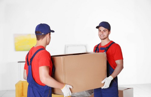 Removal team safely loading furniture with protective materials