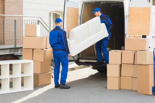Boxes, furniture, and household items prepared for a man and van move
