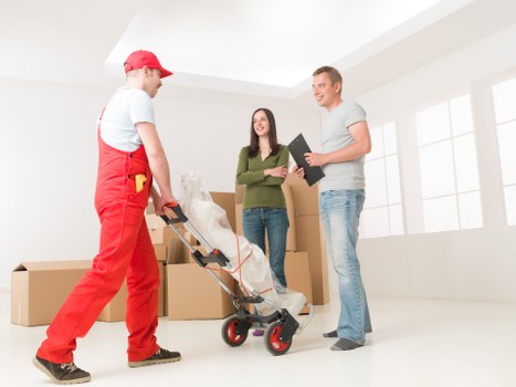 Professional removals team working safely with insurance and equipment