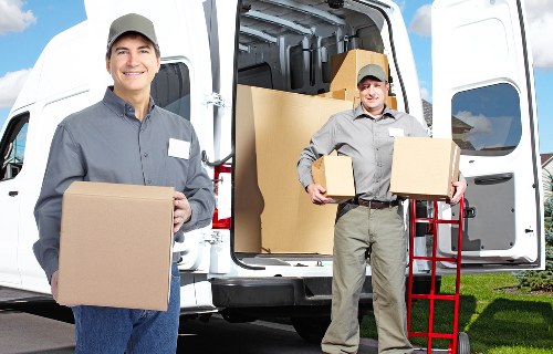 Removal team collecting a sofa from a local home