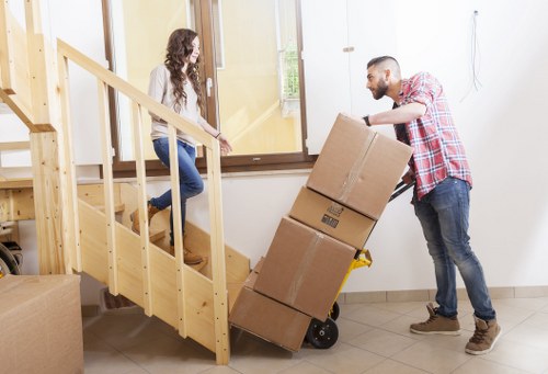Professional removal team loading household items into a moving vehicle
