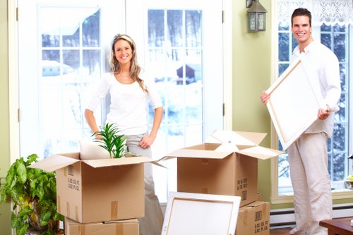 Removal team loading furniture and packed boxes for a home move