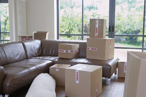 Movers organizing an office relocation with labeled equipment and desks