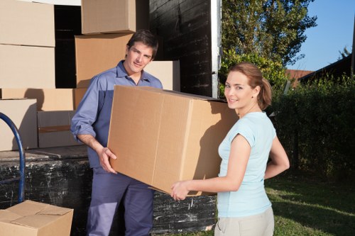 Professional movers unloading household items at a new property